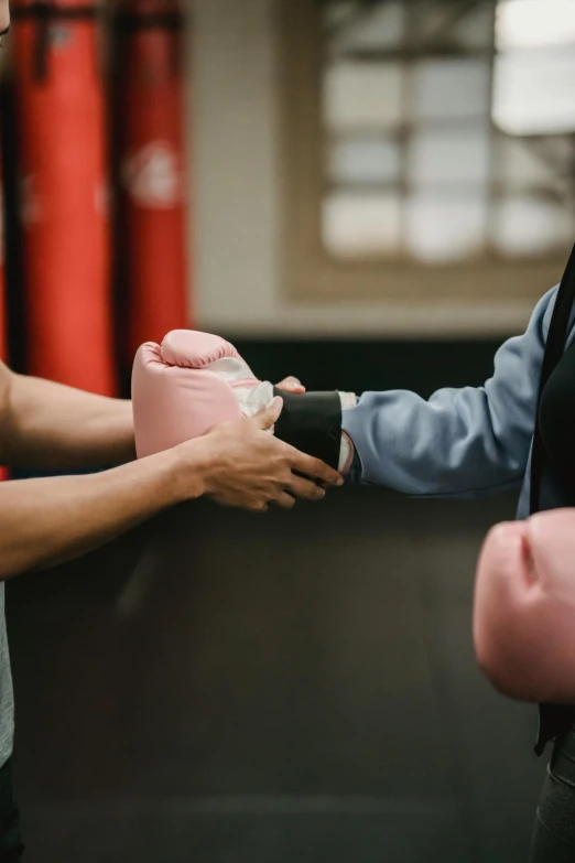 a man handing a pink piggy bank to a woman, by Arabella Rankin, happening, boxing gloves, in a dojo, panoramic shot, square