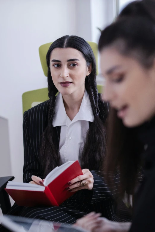 two women sitting next to each other in a room, shutterstock, renaissance, lawyer suit, holding notebook, young woman with long dark hair, official screenshot