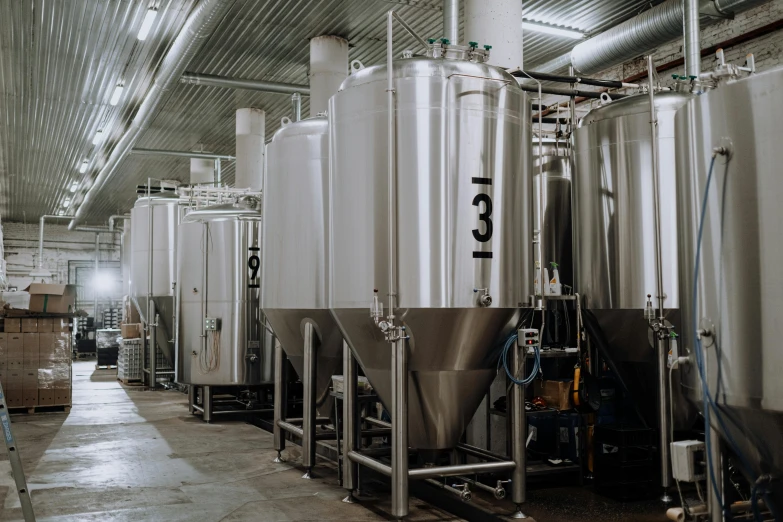 a bunch of tanks that are inside of a building, stainless steel, astri lohne, grey, malt