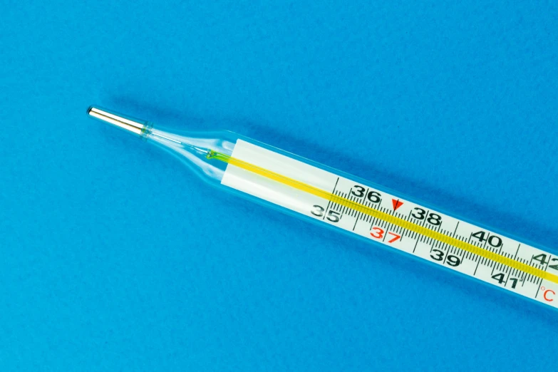 a close up of a thermometer on a blue surface, sterile colours, yellow, long, thumbnail