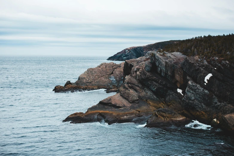 a large body of water next to a rocky shore, by Ryan Pancoast, pexels contest winner, 2 5 6 x 2 5 6 pixels, “ iron bark, multiple stories, curvacious