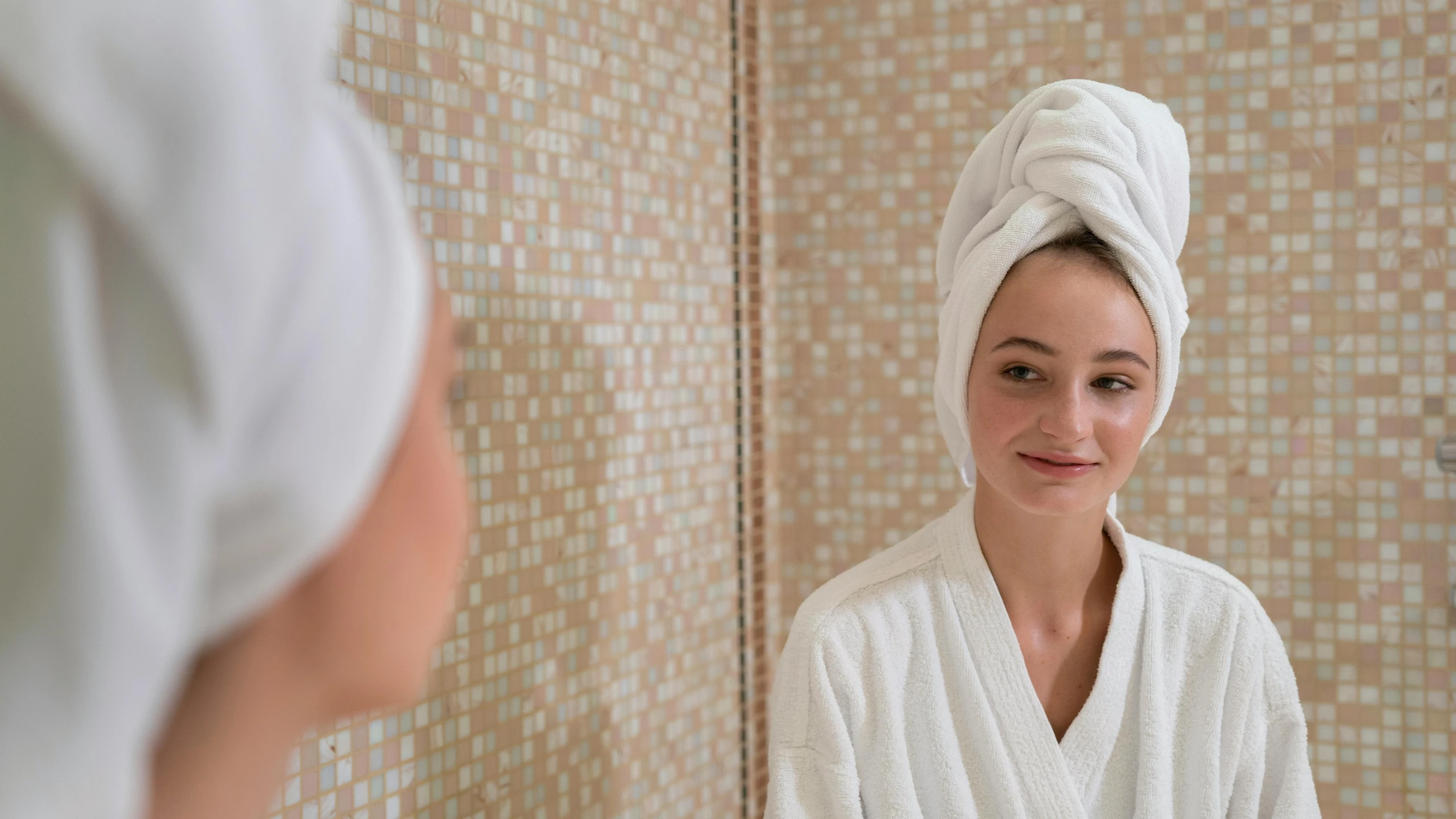 a woman standing in front of a mirror with a towel on her head, profile image, dirty linen robes, wearing white robe, head and shoulders