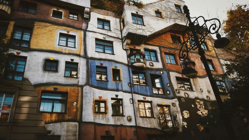 a very tall building with lots of windows, by Hundertwasser, unsplash contest winner, slovakia, 🎨🖌️, old world, in muted colors