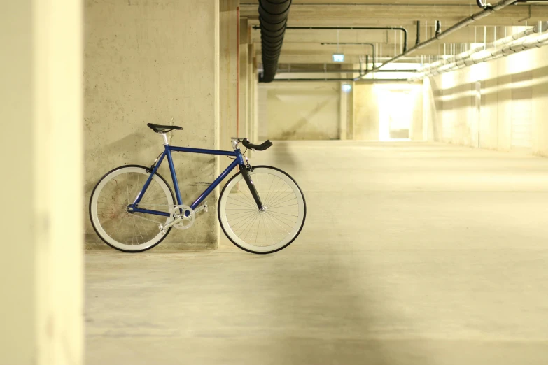 a bicycle leaning against a wall in a parking garage, by karlkka, blue print, complementary rim lights, null, indoor