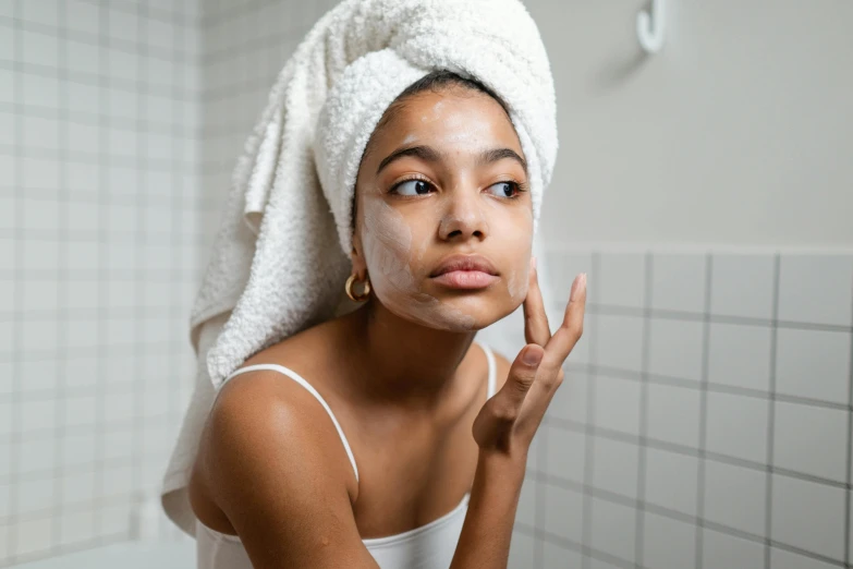 a woman with a towel wrapped around her head, by Julia Pishtar, trending on pexels, renaissance, indian girl with brown skin, some of them use gask mask, hand on cheek, late morning