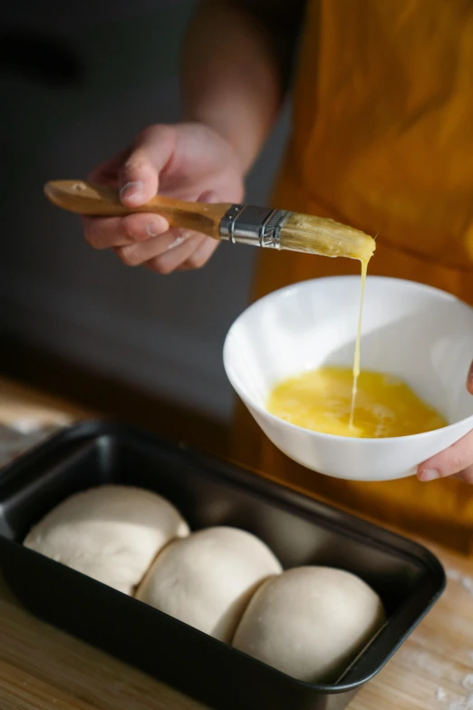 a close up of a person holding a bowl of food, butter, glazing, steamed buns, pour paint