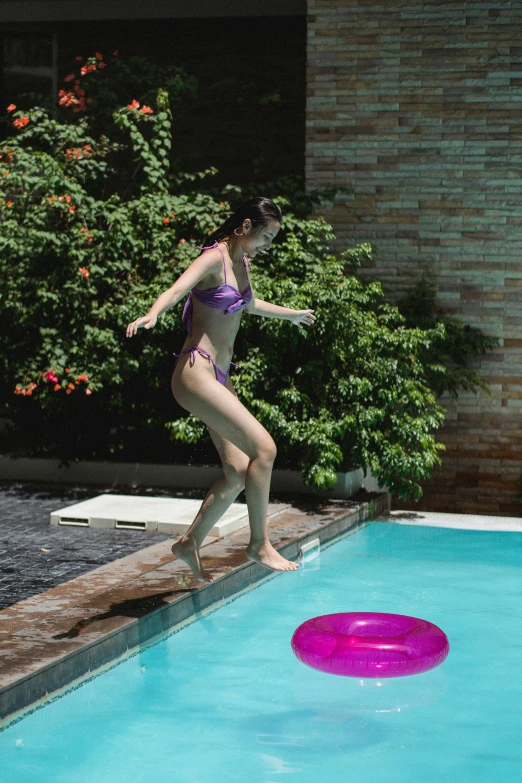 a woman in a bikini jumping into a pool with a frisbee, unsplash, conceptual art, indonesia, [ cinematic, b - roll, gemma chan