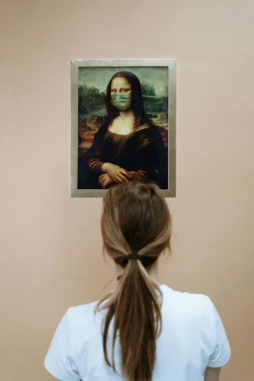 a woman standing in front of a painting, a painting, inspired by Mona Moore, trending on pexels, renaissance, surgical mask covering mouth, photographed for reuters, facing away from the camera, portrait of ((mischievous))