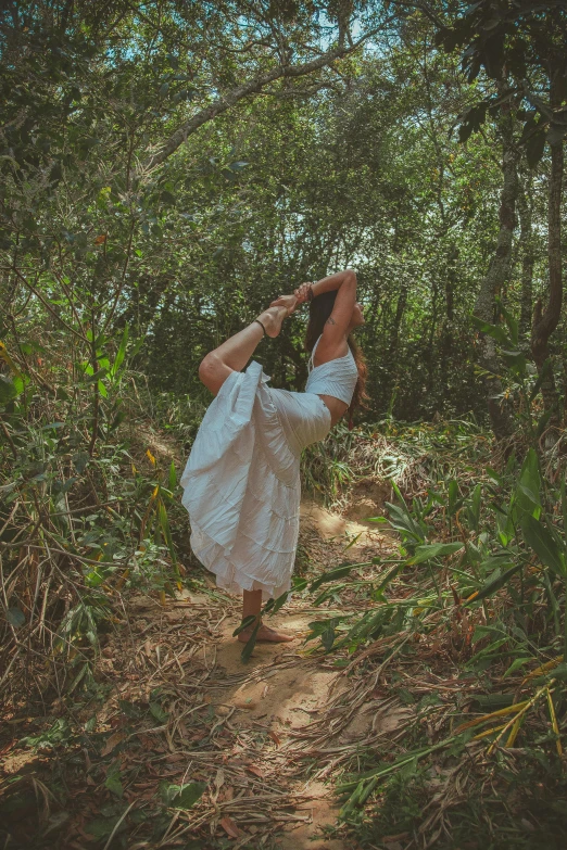 a woman doing a handstand in the woods, an album cover, inspired by Elsa Bleda, unsplash, renaissance, white sarong, in a jungle environment, profile image, woman made of plants