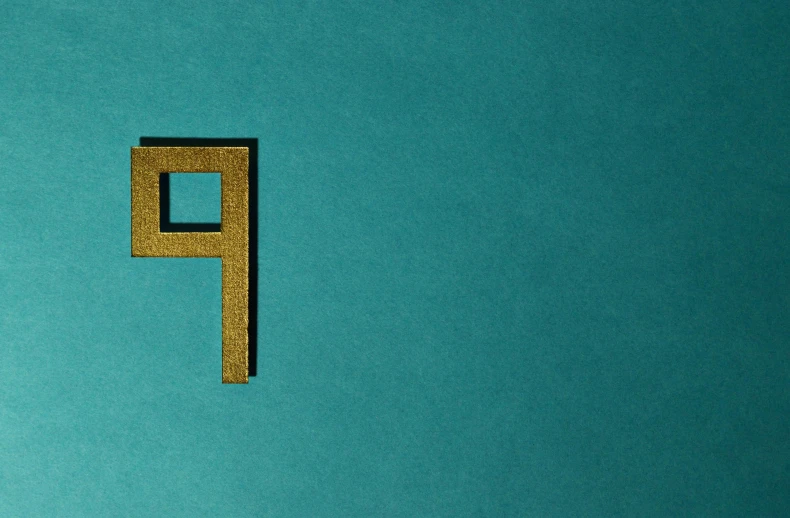 a close up of a letter p on a blue surface, an album cover, by Attila Meszlenyi, unsplash, suprematism, gold and teal color scheme, intricate environment - n 9, hebrew, brass plated