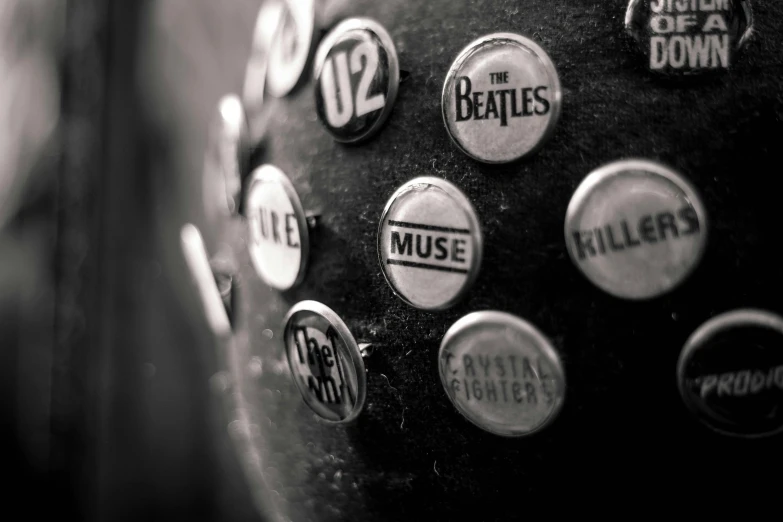 a black and white photo of buttons on a telephone, an album cover, pexels contest winner, private press, muse, rocks and metal, badge, beatle