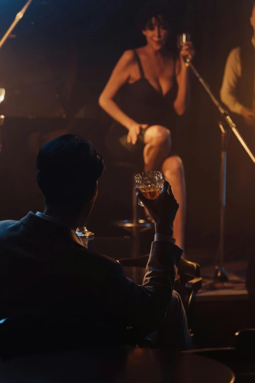 a group of people that are sitting in front of a microphone, inspired by Nan Goldin, pexels contest winner, drinking a glass of whiskey, photorealistic cinematic render, 3 jazz musicians, ( ( theatrical ) )