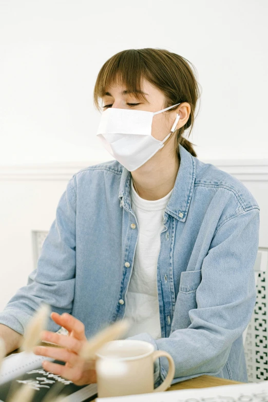 a woman sitting at a table with a laptop wearing a face mask, a picture, japanese collection product, made of lab tissue, no face mask, 4l