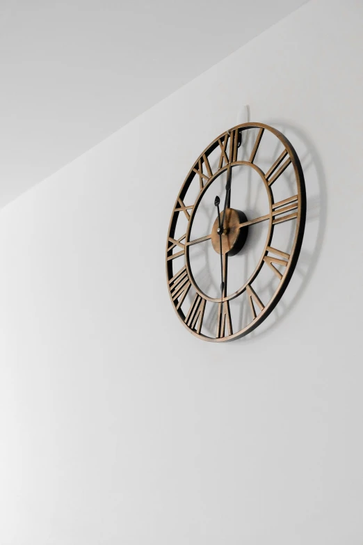 a large clock mounted to the side of a wall, pexels, minimalism, subtle gold accents, white background : 3, indoor shot, made of polished broze