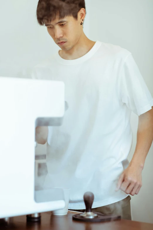 a young man standing in front of a computer, a photocopy, by Miyamoto, pexels contest winner, white t-shirt, up close shot shinji aramaki, surgery, close up to a skinny