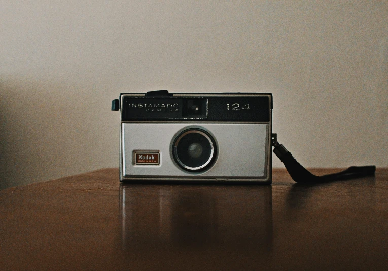 a camera sitting on top of a wooden table, inspired by Elsa Bleda, unsplash, photorealism, 1 9 7 0 s analog aesthetic, simple nostalgic, instagram picture, vintage aesthetic