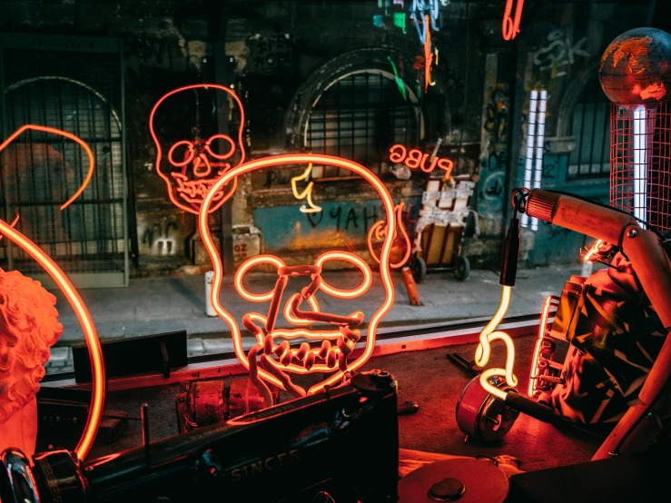 a couple of neon signs that are on the side of a building, pexels contest winner, kinetic art, there is a skull over a table, inside an old magical shop, saws, demna gvasalia