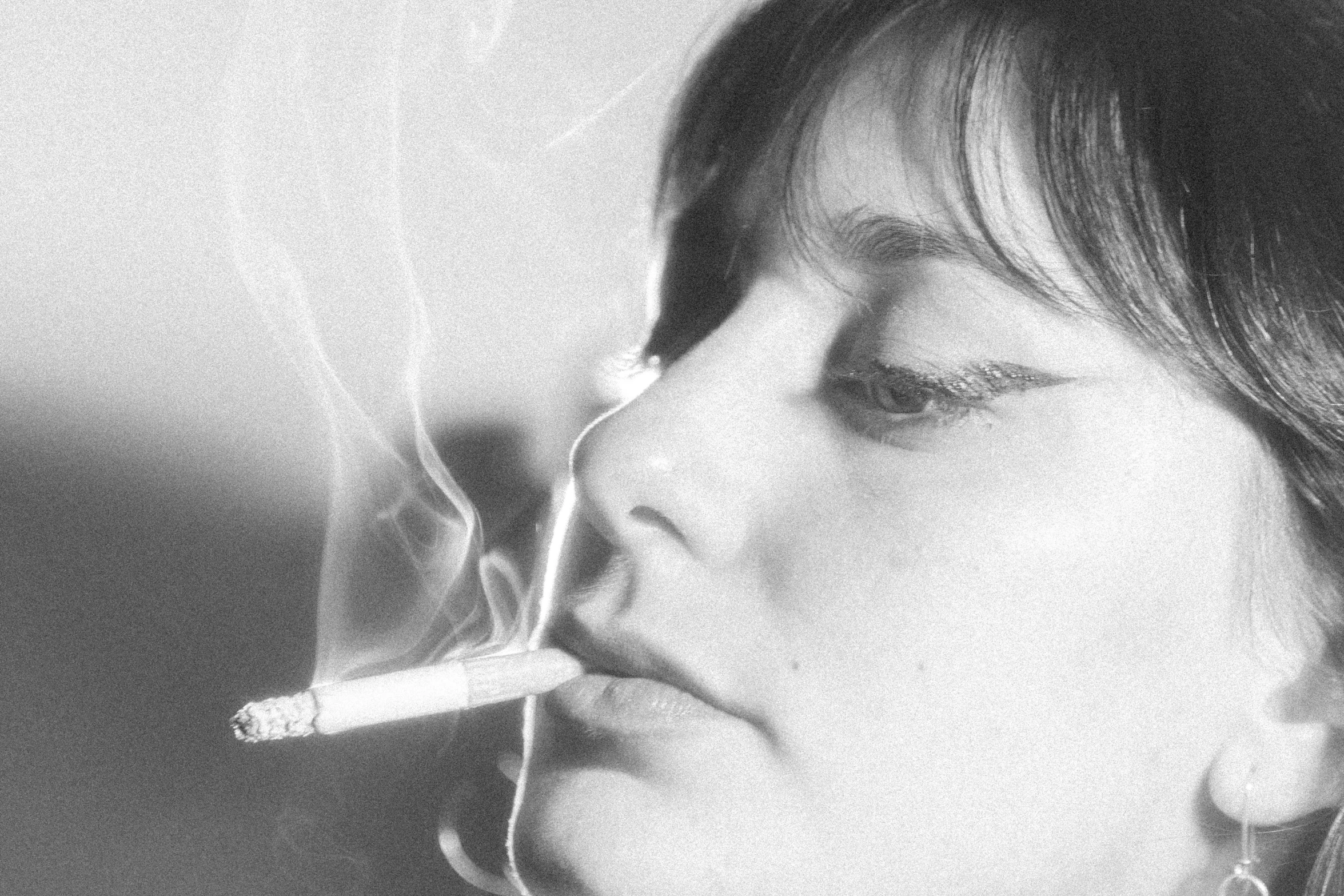 a black and white photo of a woman smoking a cigarette, a black and white photo, by Fujiwara Nobuzane, flickr, mary elizabeth winstead, nestor canavarro hyperrealist, perfect blue, mark e smith