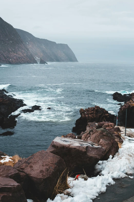 a motorcycle parked on the side of a road next to the ocean, by Daniel Lieske, pexels contest winner, snowy fjord, waves crashing at rocks, 2 5 6 x 2 5 6 pixels, brown