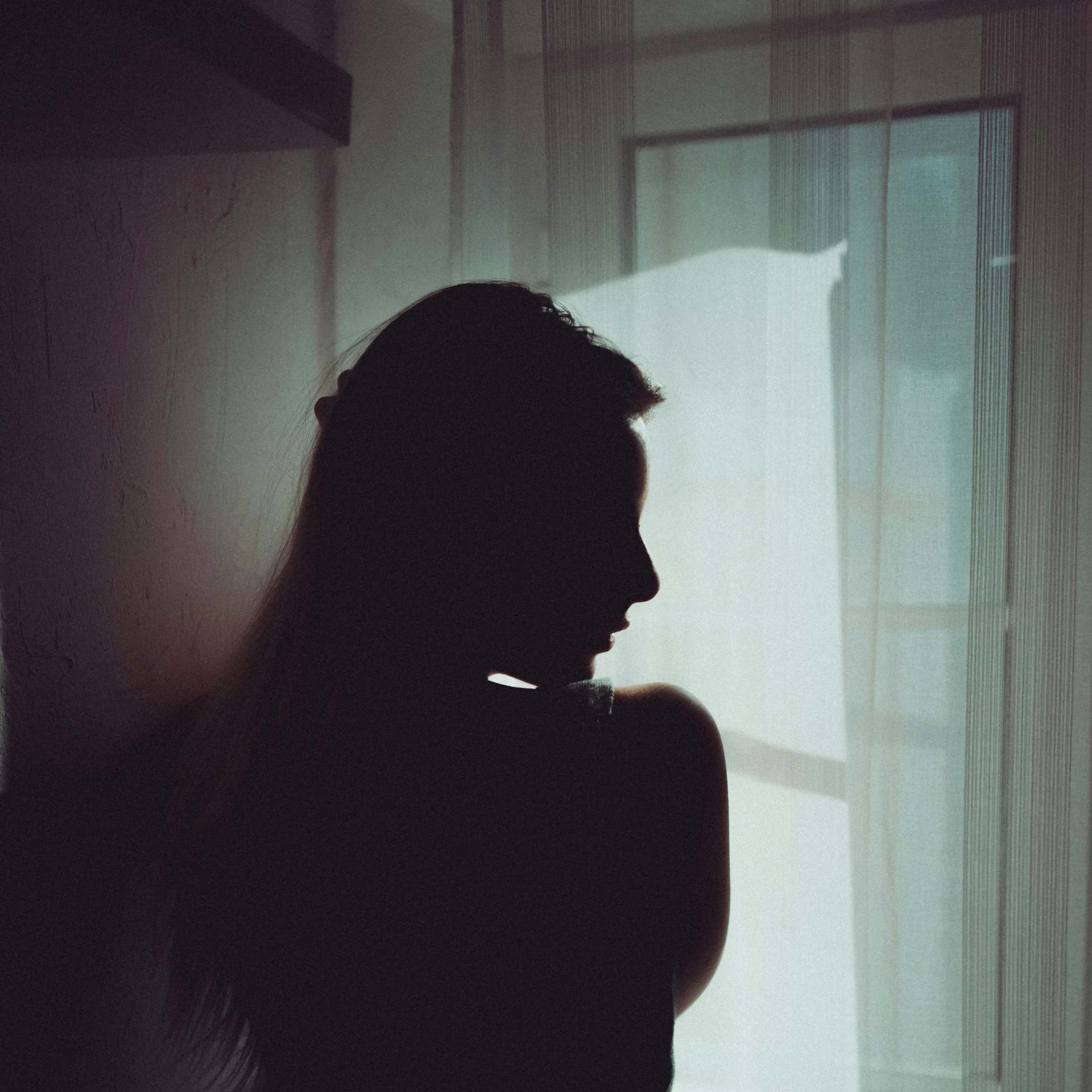 a silhouette of a woman standing in front of a window, a polaroid photo, inspired by Elsa Bleda, pexels contest winner, romanticism, depressed girl portrait, soft shadow, silhouette of man, medium format. soft light