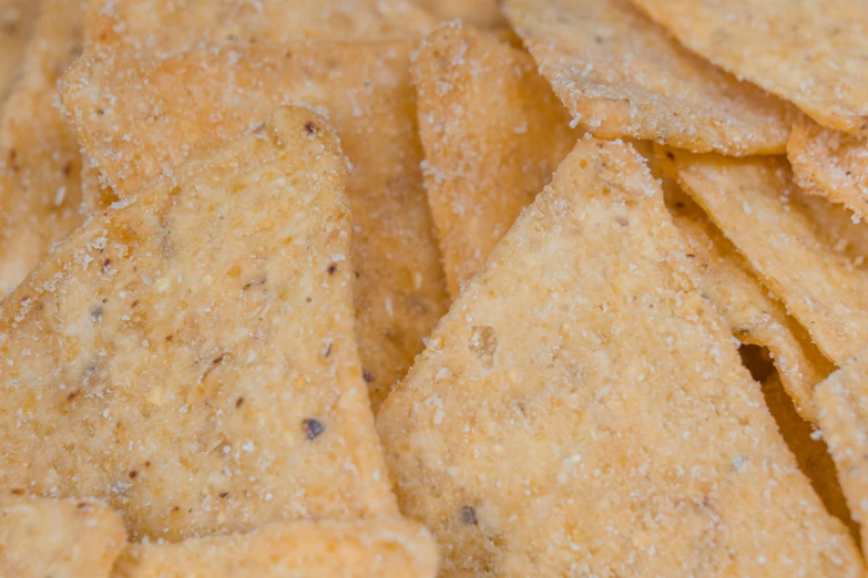 a pile of crackers sitting on top of a table, zoomed in shots, detailed product image, nachos, square