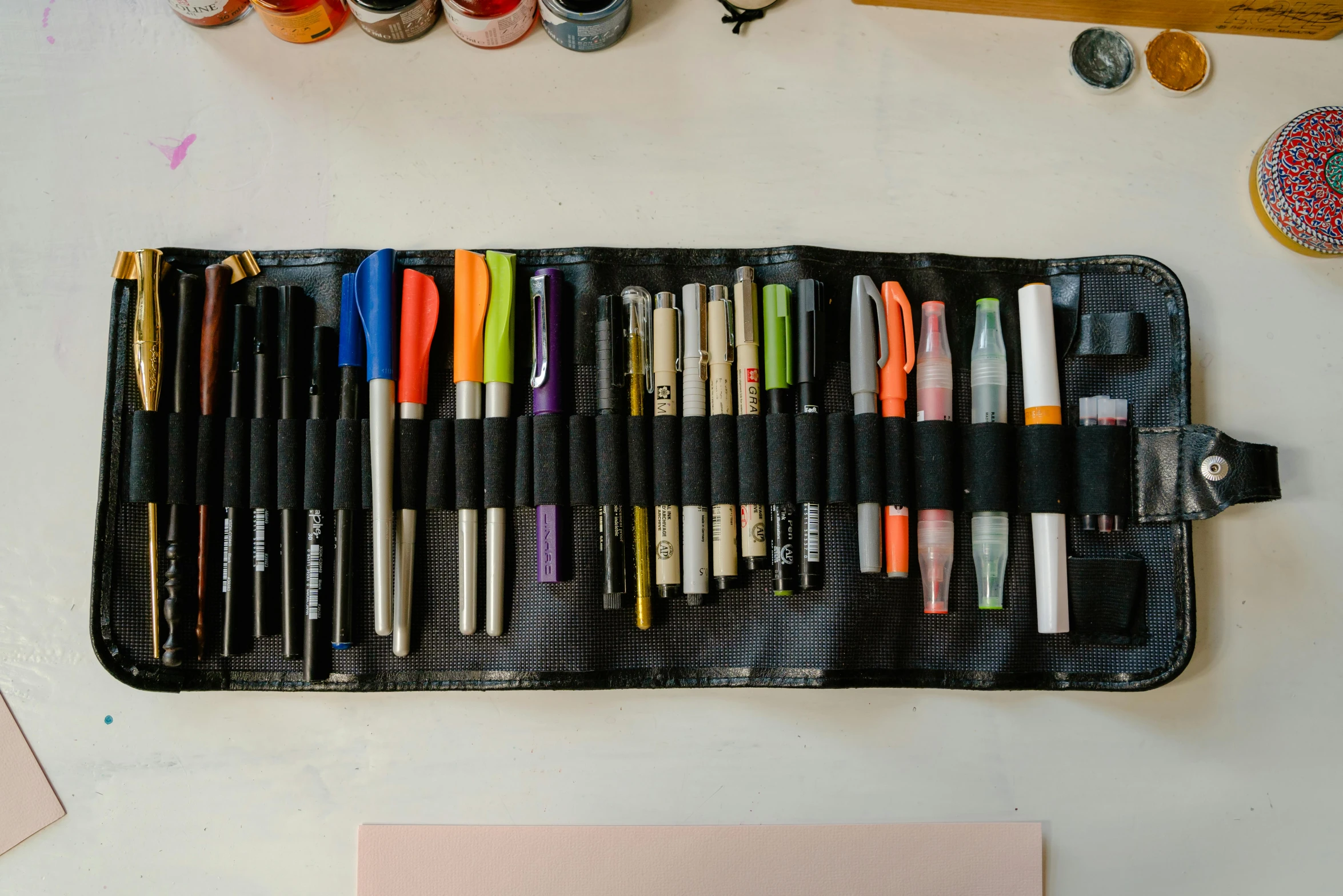 a roll of art supplies sitting on top of a table, by Andrée Ruellan, unsplash, black ink & copic markers, tool belt, organized, rectangle