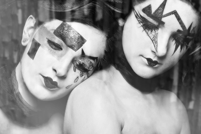 a black and white photo of two women with face paint, inspired by Grete Stern, tumblr, broken mirrors composition, boudoir, geisha makeup, bodypaint
