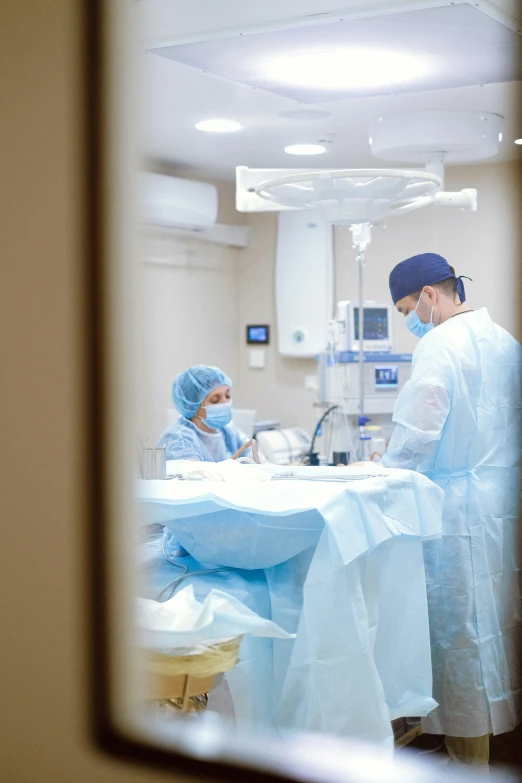 a couple of people that are in a room, operating room, profile image