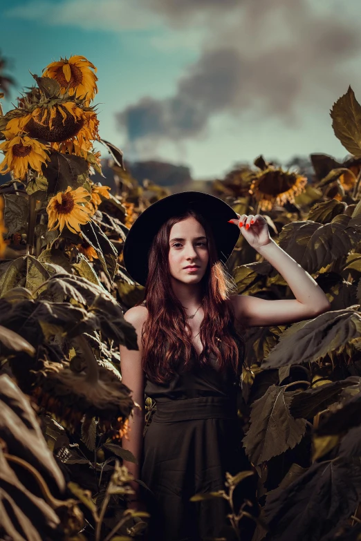 a woman standing in a field of sunflowers, a picture, by irakli nadar, pexels contest winner, renaissance, wearing black dress and hat, girl with brown hair, dslr photo of a pretty teen girl, 5 0 0 px models