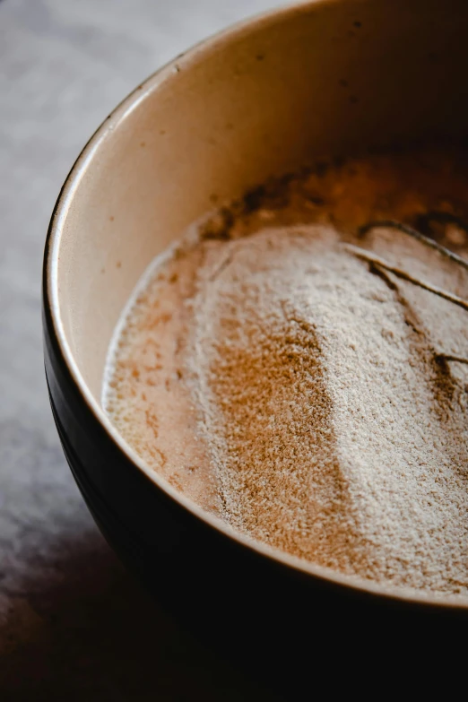 a bowl of soup with a whisk in it, a portrait, trending on pexels, process art, muted brown, powdered sugar, close up high detailed, cappuccino