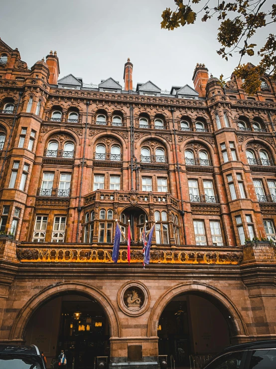 a building with cars parked in front of it, inspired by John Atkinson Grimshaw, unsplash, art nouveau, manchester, hotel, profile image