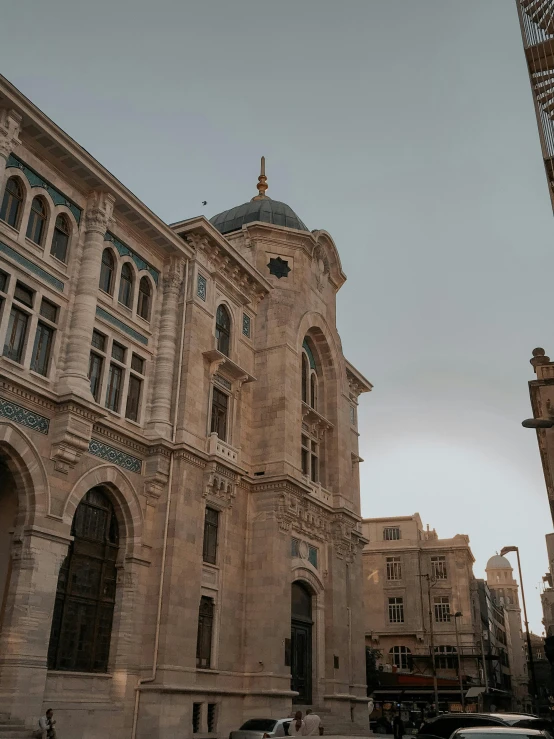 a clock that is on the side of a building, inspired by Osman Hamdi Bey, pexels contest winner, renaissance, big arches in the back, alexandria\'s genesis, parisian buildings, grey