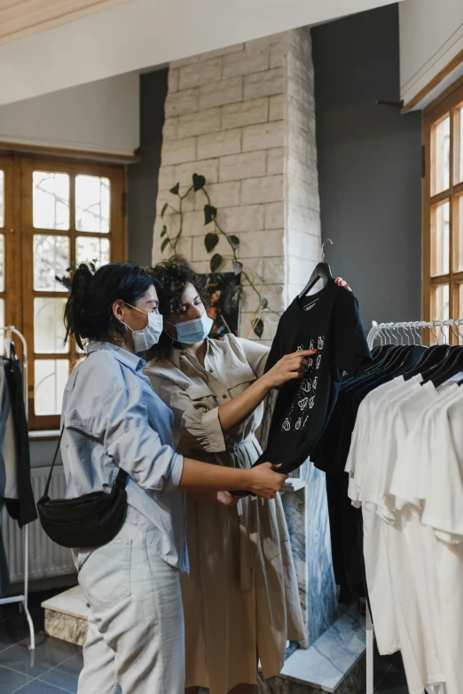 a couple of women standing next to each other in a room, pexels contest winner, inspect in inventory image, people are wearing masks, garments, thumbnail