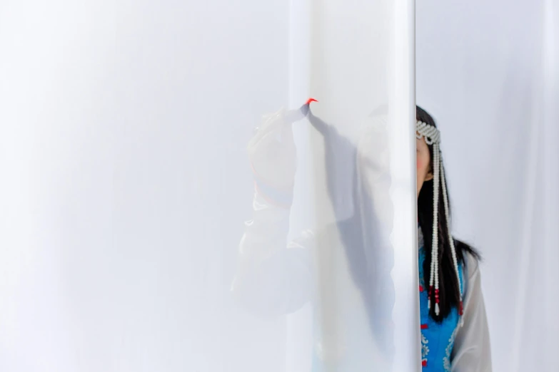 a woman writing on a white board with a marker, inspired by Scarlett Hooft Graafland, interactive art, glossy white metal, inuit heritage, exiting from a wardrobe, close face view