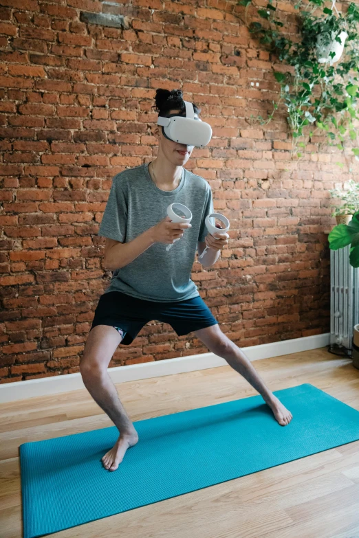 a man standing on a yoga mat in front of a brick wall, a digital rendering, reddit, wearing vr goggles, akali, using a exoskeleton, zachary corzine