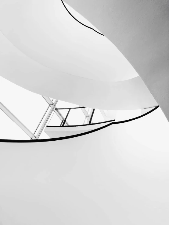 a black and white photo of a spiral staircase, inspired by Ned M. Seidler, unsplash contest winner, light and space, inside white room, sails, white in color, norman foster