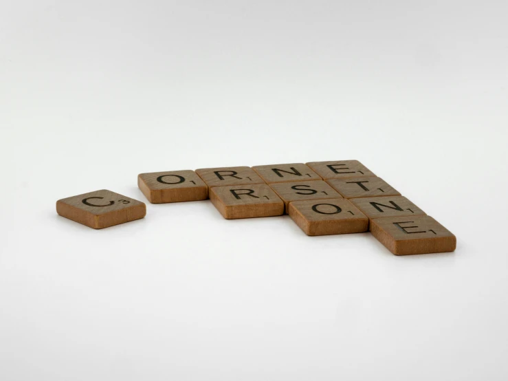 a group of scrabbles sitting on top of each other, an album cover, by Cornelia Parker, conceptual art, sandstone, detailed product image, eye level shot, gwent