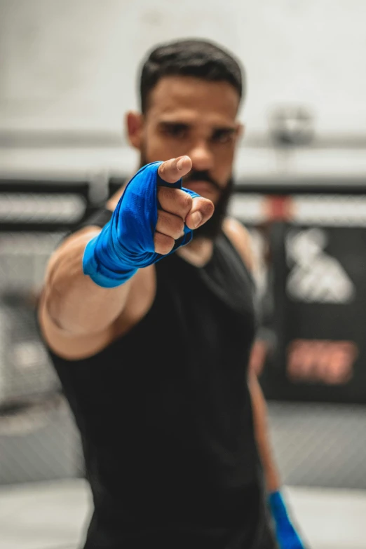 a man in a black shirt and blue boxing gloves, by Adam Marczyński, pexels contest winner, doing a thumb up, square, caio santos, bandages