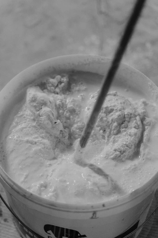 a cup of ice cream with a spoon sticking out of it, an ambient occlusion render, reddit, process art, made of cement, still from film, powdered wig, digging