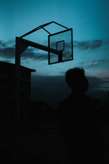 a person standing in front of a basketball hoop, by Matija Jama, unsplash contest winner, silhouetted, lights off, 15081959 21121991 01012000 4k, instagram post
