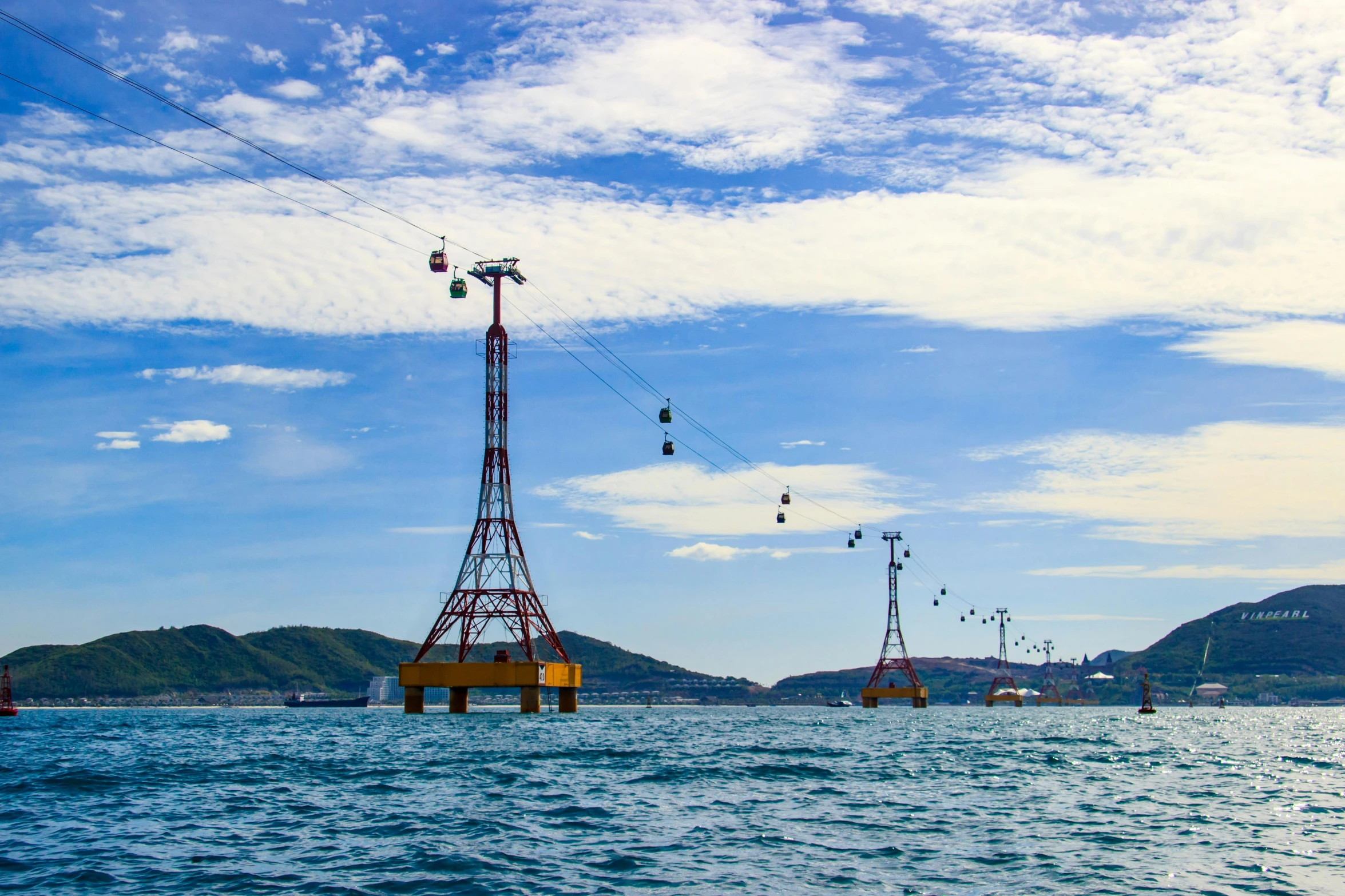 a group of boats floating on top of a body of water, wires flying in the air, trams, photo of the middle of the ocean, joongwon jeong