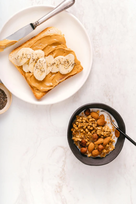 a close up of a plate of food on a table, trending on pexels, peanuts, toast, banana, manuka