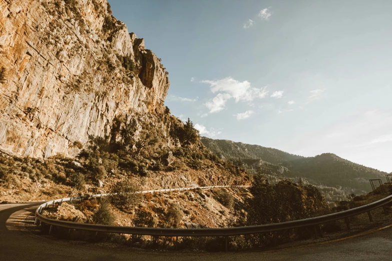 a car driving down a winding mountain road, a picture, unsplash contest winner, les nabis, cyprus, panoramic anamorphic, high quality product image”