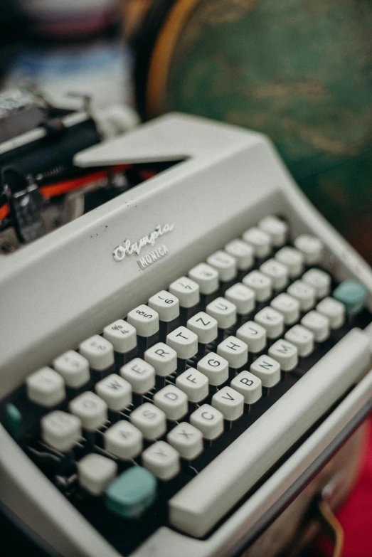 a close up of a typewriter on a table, in white lettering, retro aesthetic, multiple stories, white colors