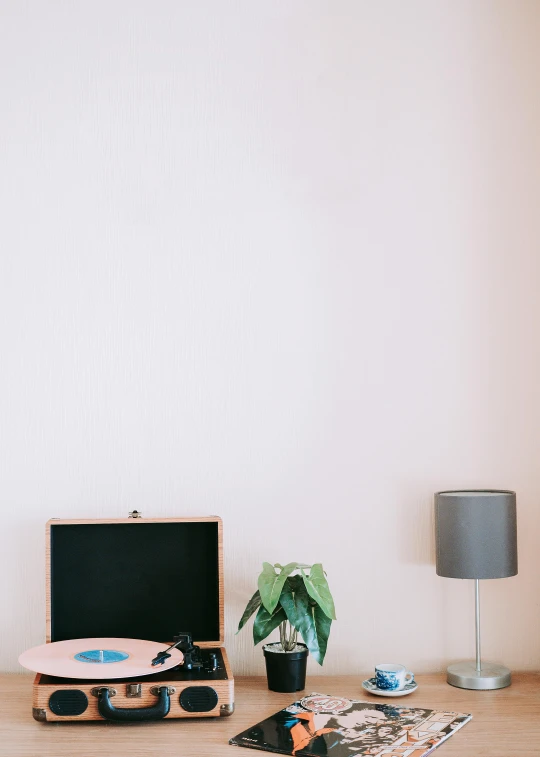 a record player sitting on top of a wooden table, a minimalist painting, trending on unsplash, postminimalism, ((pink)), office furniture, background image, studyng in bedroom