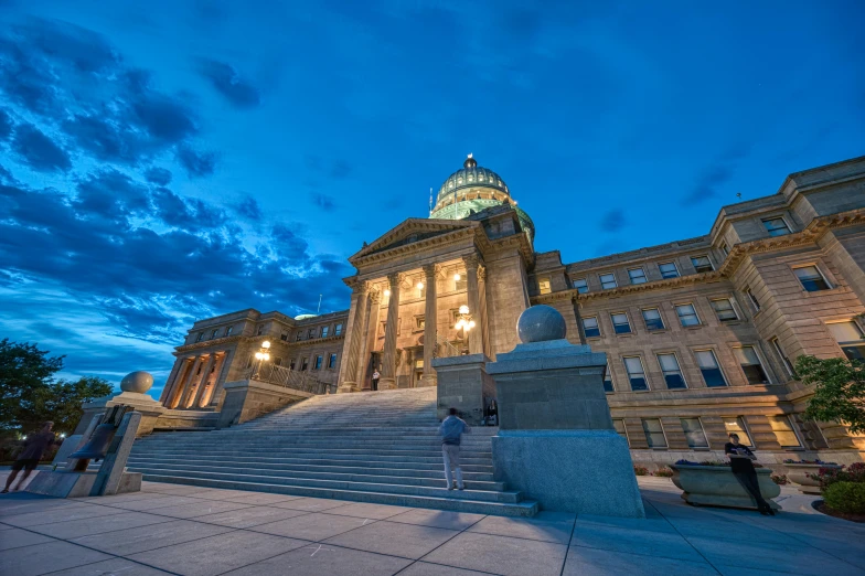 the state capitol building is lit up at night, an album cover, by Greg Spalenka, unsplash contest winner, montana, large staircase, summer evening, thumbnail