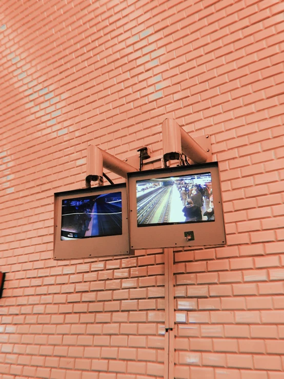 two televisions mounted to the side of a brick wall, unsplash, video art, dashcam footage, from the grand budapest hotel, high angle security camera feed, 🎀 🍓 🧚