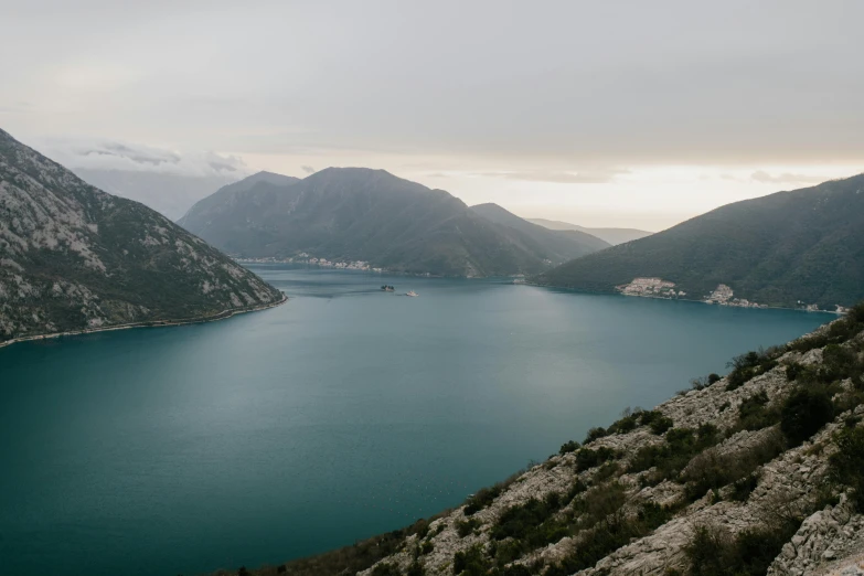 a large body of water surrounded by mountains, by Sebastian Spreng, unsplash contest winner, hurufiyya, croatian coastline, high quality product image”, multiple stories, dramatic”