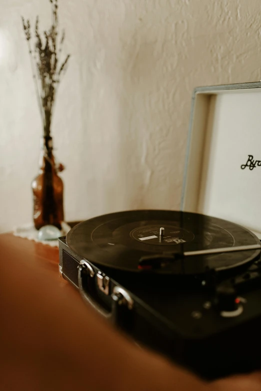 a record player sitting on top of a wooden table, in a room, detailed product image, blooming, b - roll