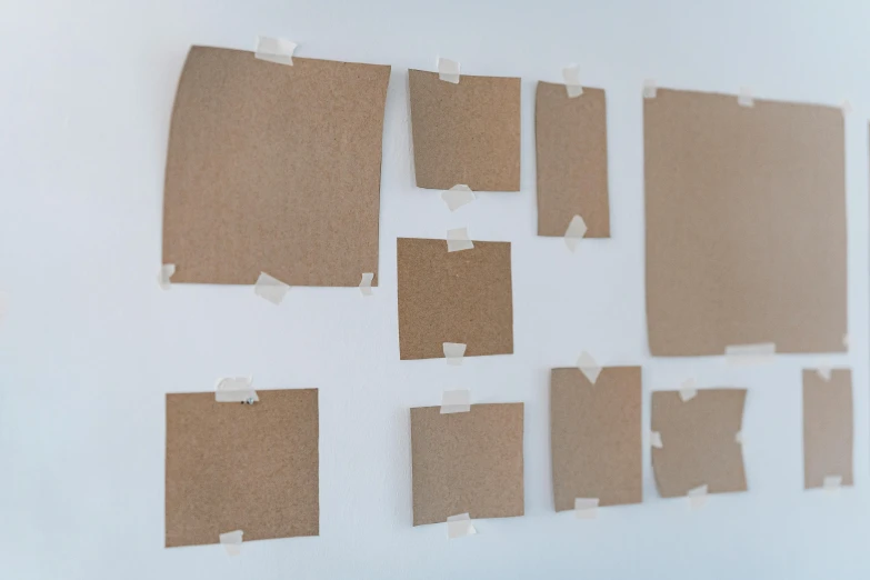 several pieces of cardboard taped to a wall, unsplash, visual art, square pictureframes, brown, olivia kemp, whiteboards